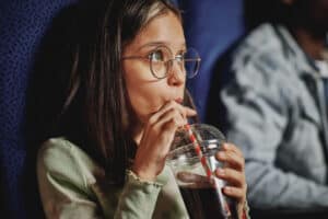Girl Drinking Cola At Cinema